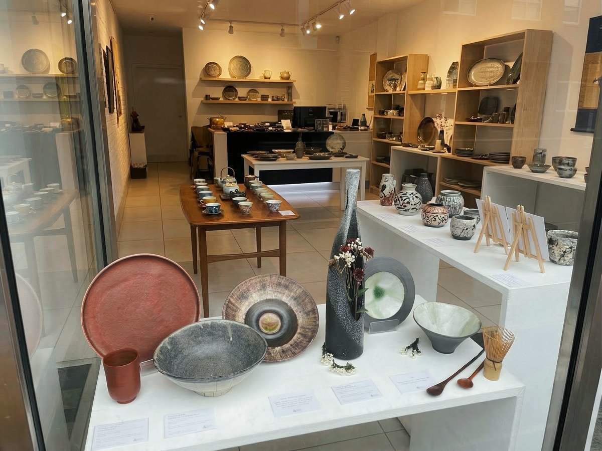 Interior of the Obsidian & Flame gallery, shelves and tables displaying ceramics